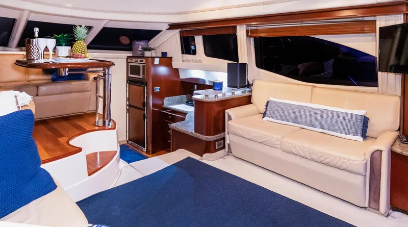 Slide: The Image of Luxurious interior of 2006 Sea Ray 44 Sedan Bridge yacht with elegant seating and dining area. - 20
