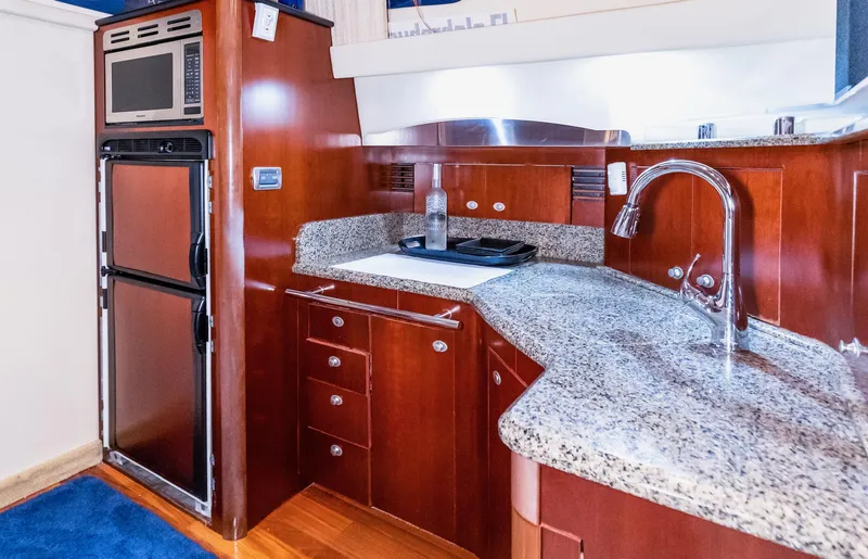 Slide: The Image of Luxurious kitchen area in a 2006 Sea Ray 44 Sedan Bridge yacht with granite countertops. - 22