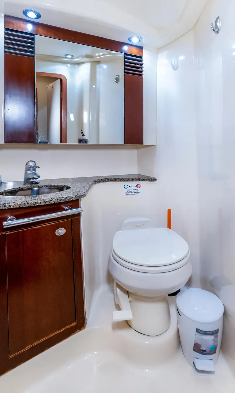 Slide: The Image of Luxurious bathroom in 2006 Sea Ray 44 Sedan Bridge yacht with modern fixtures and wood accents. - 25