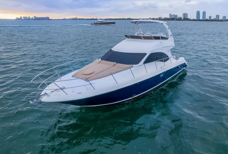 Slide: The Image of 2006 Sea Ray 44 Sedan Bridge yacht on calm waters at sunset. - 3
