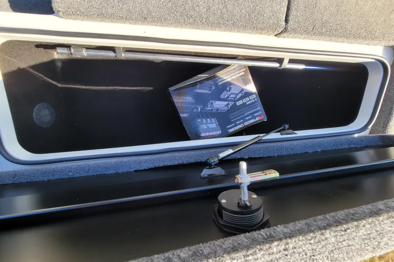 Slide: The Image of 2024 Triton 179 TrX storage compartment with hydraulic lift and manual. - 10