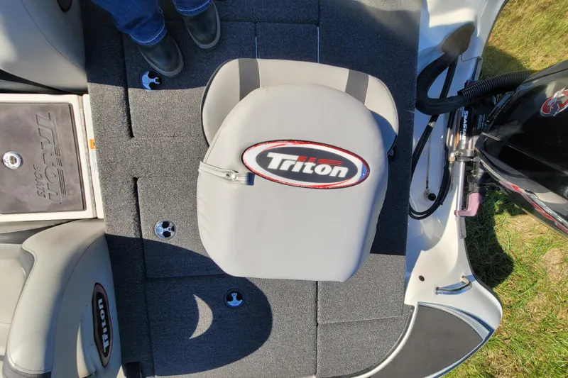 Slide: The Image of 2024 Triton 179 TrX boat interior with branded seat and carpeted flooring. - 17