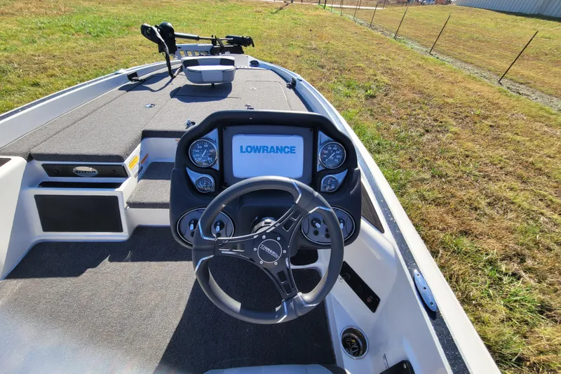 Slide: The Image of 2024 Triton 179 TrX boat dashboard with Lowrance display and steering wheel. - 4