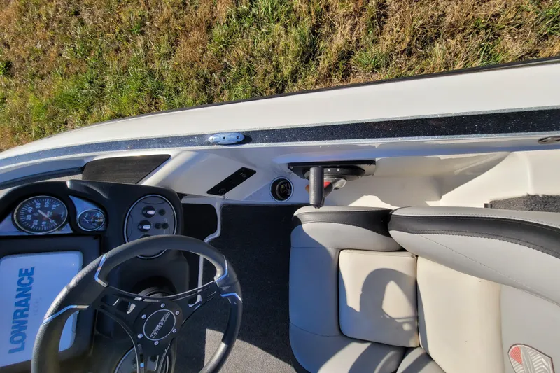 Slide: The Image of 2024 Triton 179 TrX boat interior with steering wheel and control panel. - 5