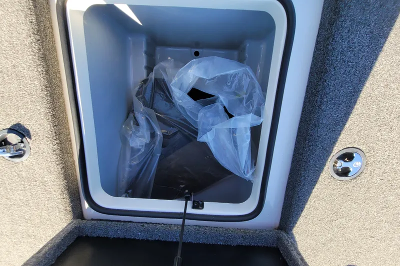 Slide: The Image of Storage compartment of 2024 Triton 179 TrX boat with plastic liner. - 9