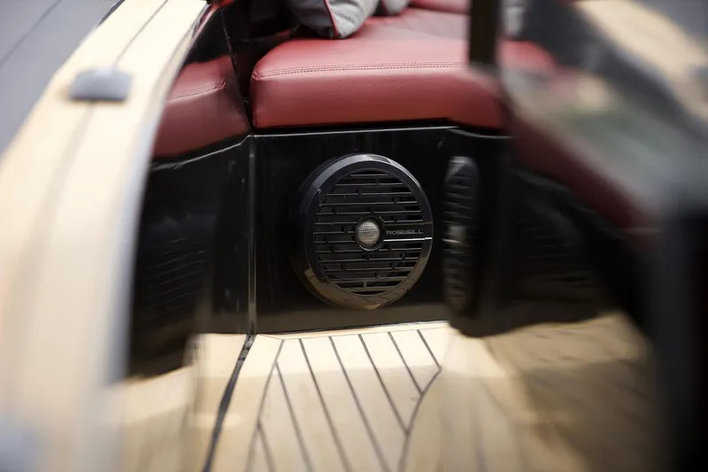 Slide: The Image of 2023 Revolt Comfort 47 boat interior with red seating and speaker system. - 14
