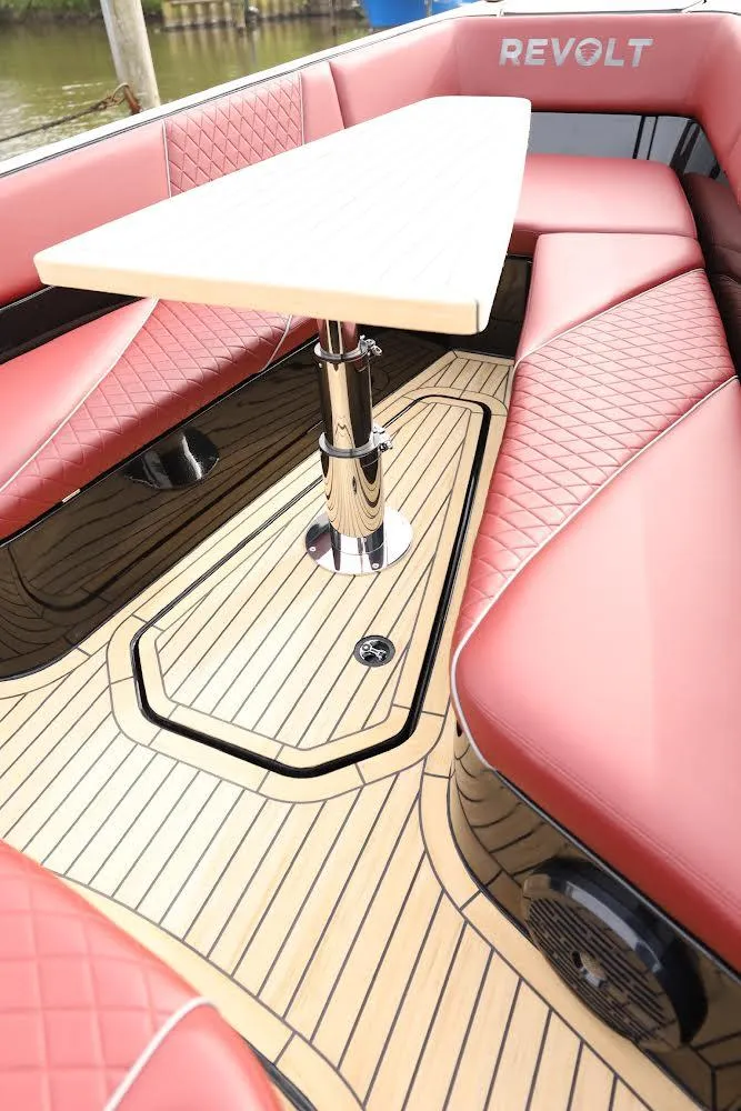 Slide: The Image of Luxurious 2023 Revolt Comfort 47 boat interior with red seating and elegant wood flooring. - 16