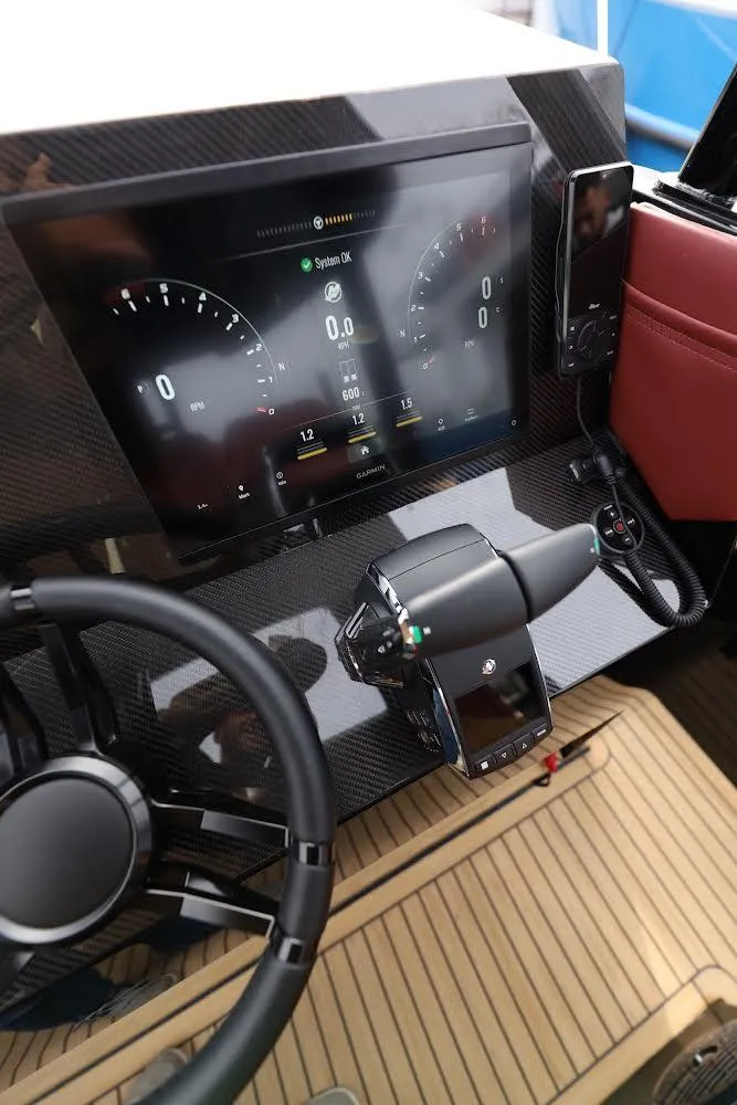 Slide: The Image of 2023 Revolt Comfort 47 dashboard with digital display and steering wheel. - 19