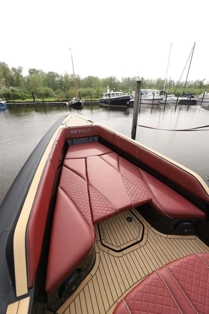 Slide: The Image of 2023 Revolt Comfort 47 boat with luxurious red seating and sleek design. - 20