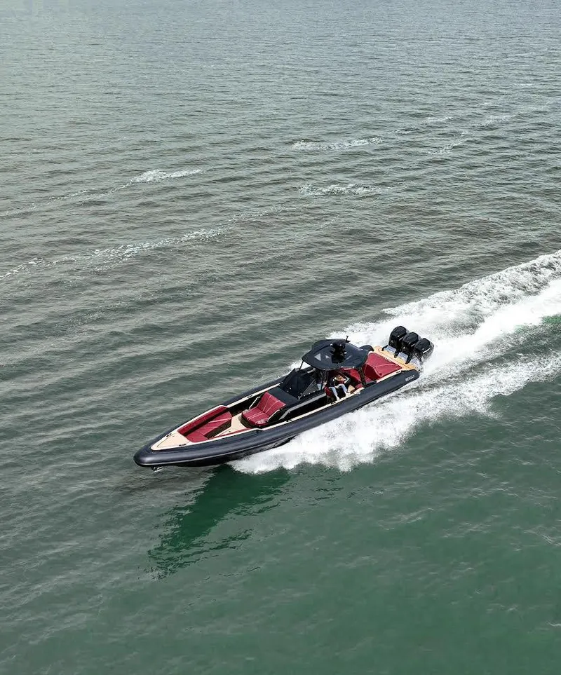 Slide: The Image of 2023 Revolt Comfort 47 boat cruising on open water, showcasing sleek design and powerful engines. - 4