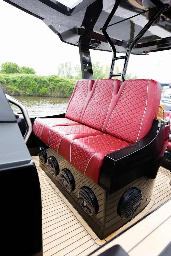Slide: The Image of Luxurious red seating on 2023 Revolt Comfort 47 boat, featuring diamond stitching and sleek design. - 5