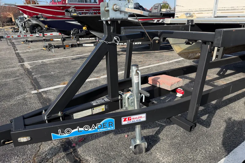 Slide: The Image of Trailer hitch of a 2004 SunChaser 820 Cruise boat in a parking lot. - 2