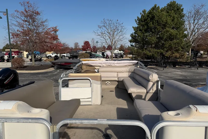 Slide: The Image of 2004 SunChaser 820 Cruise pontoon boat with beige seating, parked outdoors. - 3