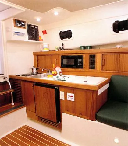 Slide: The Image of Mainship Pilot 30 boat, 2000 model, featuring cockpit and steering wheel. - 13