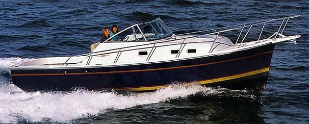 Slide: The Image of 2000 Mainship Pilot 30 boat deck with seating and storage at marina. - 14