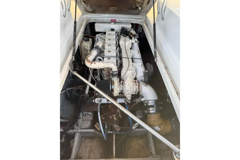 Slide: The Image of 2000 Mainship Pilot 30 boat cockpit with steering wheel and cushioned seating. - 16