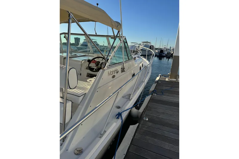 Slide: The Image of 2000 Mainship Pilot 30 boat docked at marina under cloudy sky. - 4