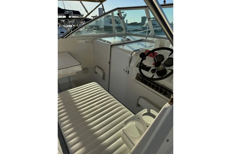 Slide: The Image of 2000 Mainship Pilot 30 docked at marina under cloudy sky. - 5