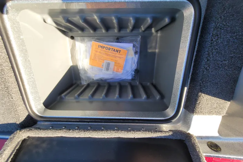 Slide: The Image of Storage compartment of 2024 Triton 179 TrX boat with important documents inside. - 14