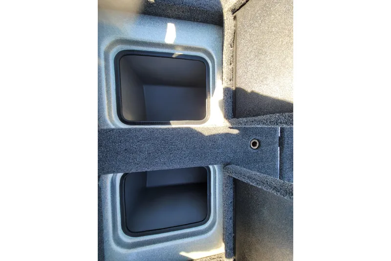 Slide: The Image of 2024 Triton 179 TrX storage compartments with carpeted interior. - 15