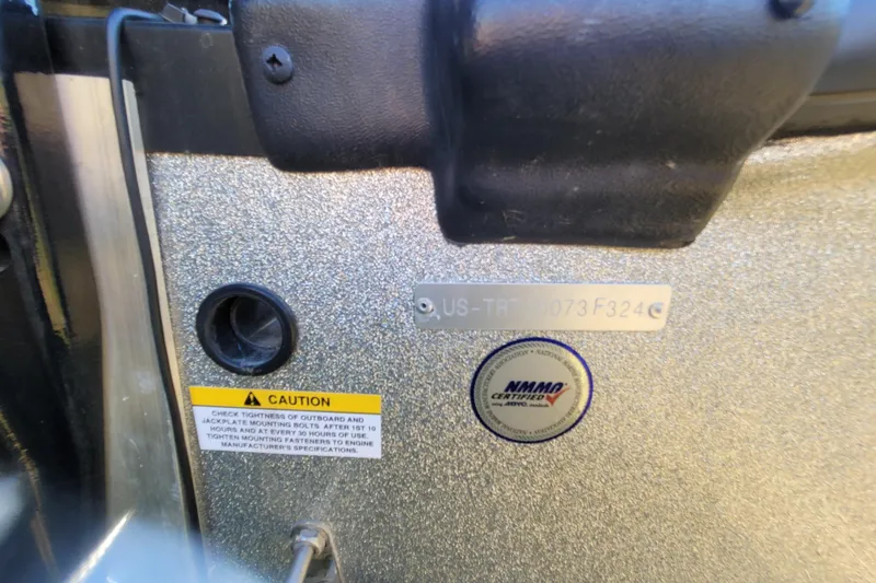 Slide: The Image of 2024 Triton 179 TrX boat detail with caution label and certification sticker. - 2