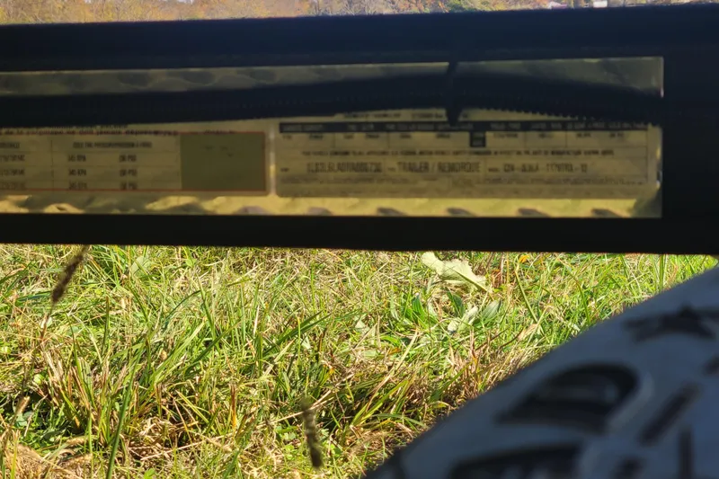 Slide: The Image of 2024 Triton 179 TrX trailer label with grassy background. - 4