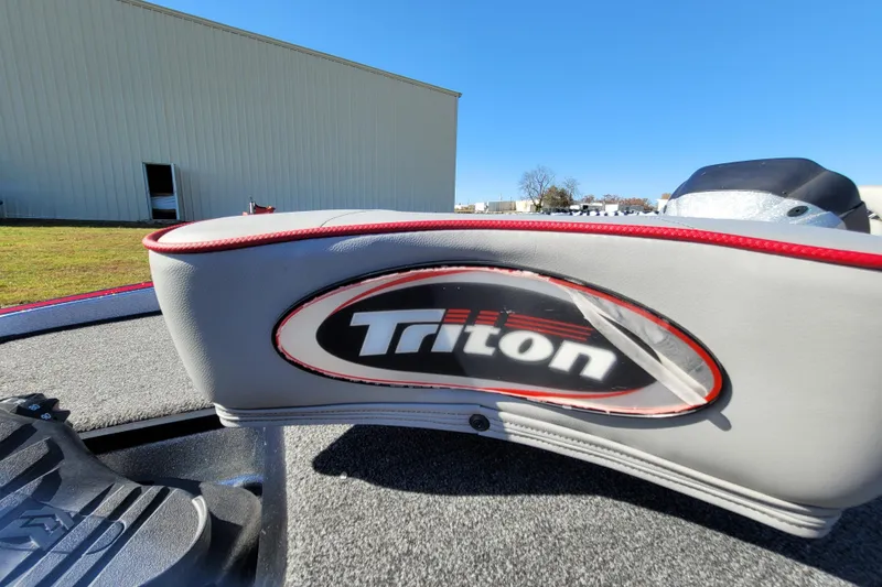 Slide: The Image of 2024 Triton 179 TrX boat seat with logo, outdoor setting, clear sky. - 5