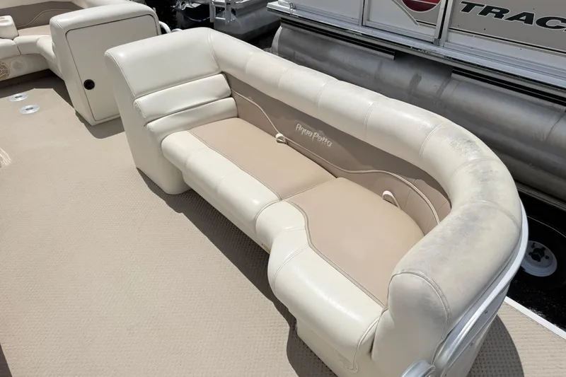 Slide: The Image of 2005 Aqua Patio 240 boat seating with beige and white upholstery, showcasing comfortable design. - 6