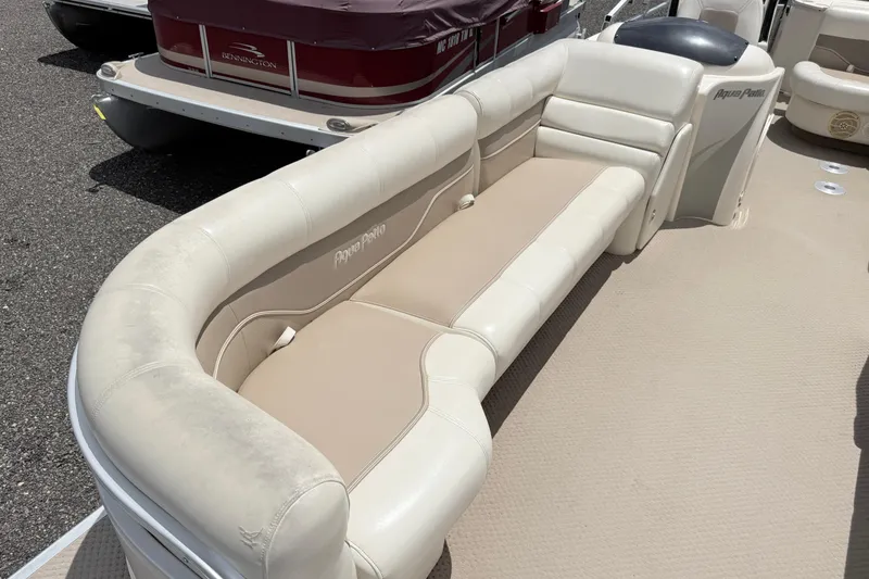 Slide: The Image of 2005 Aqua Patio 240 boat interior with beige seating and carpeted flooring. - 5