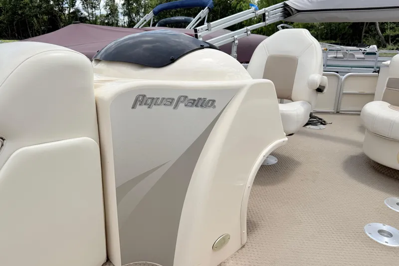 Slide: The Image of 2005 Aqua Patio 240 boat interior with beige seating and sleek design. - 14