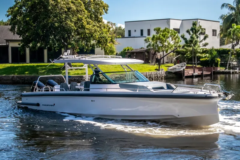 Slide: The Image of 2024 Axopar 37 Sun Top cruising on a scenic waterway. - 6