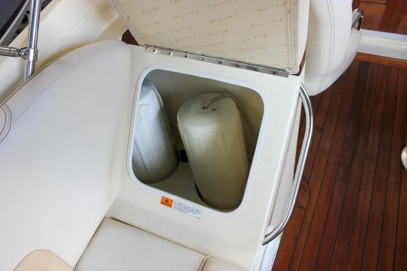 Slide: The Image of 2011 Chris-Craft Corsair 28 boat in a showroom, showcasing sleek design and craftsmanship. - 12