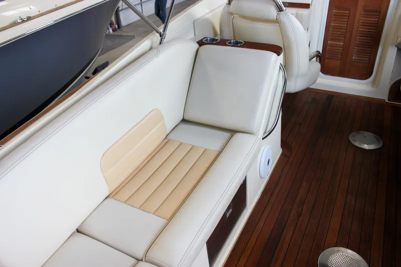 Slide: The Image of 2011 Chris-Craft Corsair 28 with blue bimini top in a garage setting. - 13