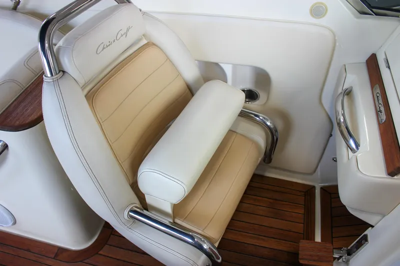 Slide: The Image of 2011 Chris-Craft Corsair 28 boat with elegant wooden deck and cushioned seating. - 15
