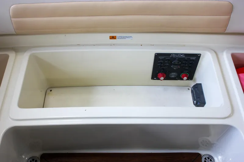 Slide: The Image of 2011 Chris-Craft Corsair 28 interior with beige leather seating and wooden flooring. - 17