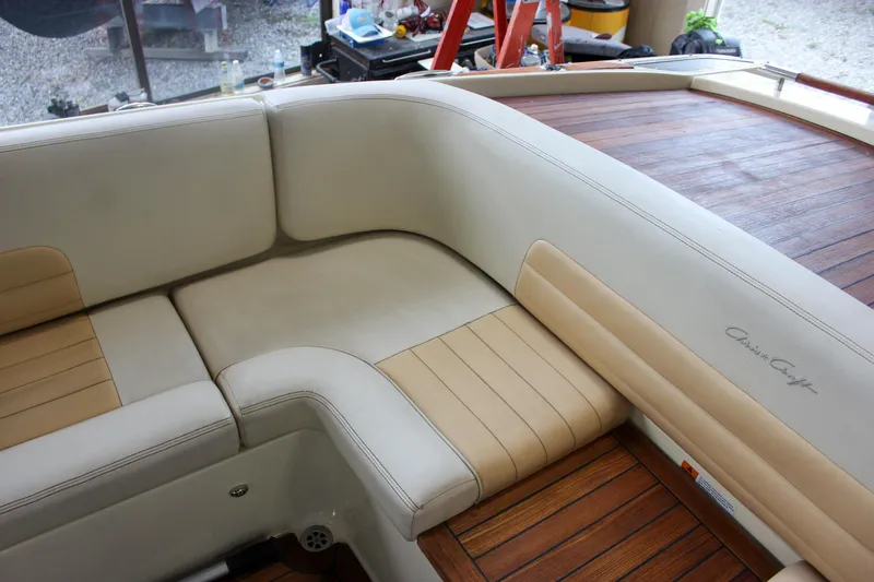 Slide: The Image of 2011 Chris-Craft Corsair 28 interior with white seats and wooden cup holders. - 20