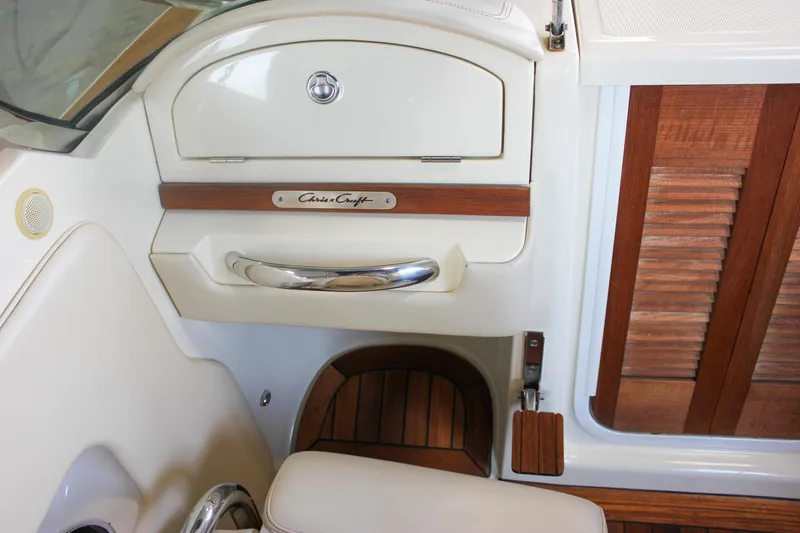 Slide: The Image of Luxurious seating in 2011 Chris-Craft Corsair 28 boat, featuring elegant wood and leather design. - 21