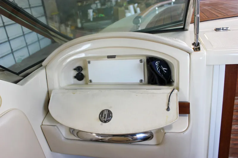 Slide: The Image of 2011 Chris-Craft Corsair 28 interior with luxurious beige leather seating and wooden accents. - 22