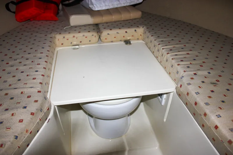 Slide: The Image of 2011 Chris-Craft Corsair 28 boat interior with beige leather seating and wooden flooring. - 26