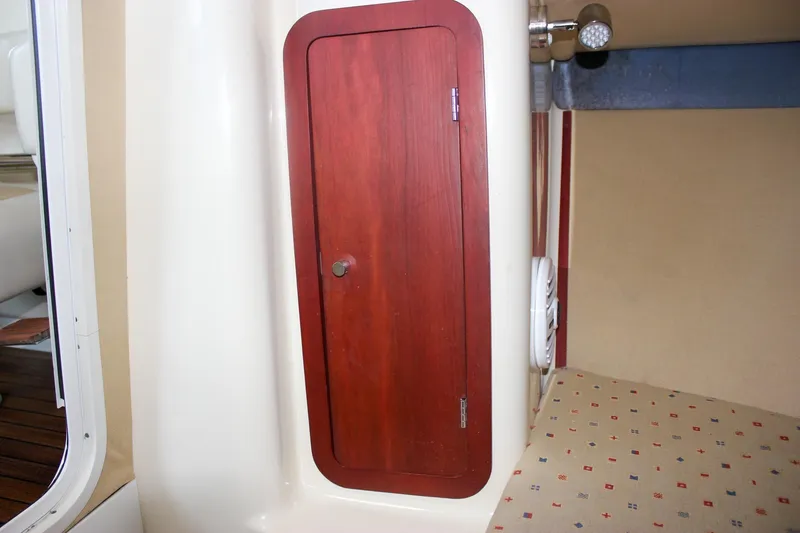 Slide: The Image of 2011 Chris-Craft Corsair 28 boat with wooden deck in a workshop setting. - 29