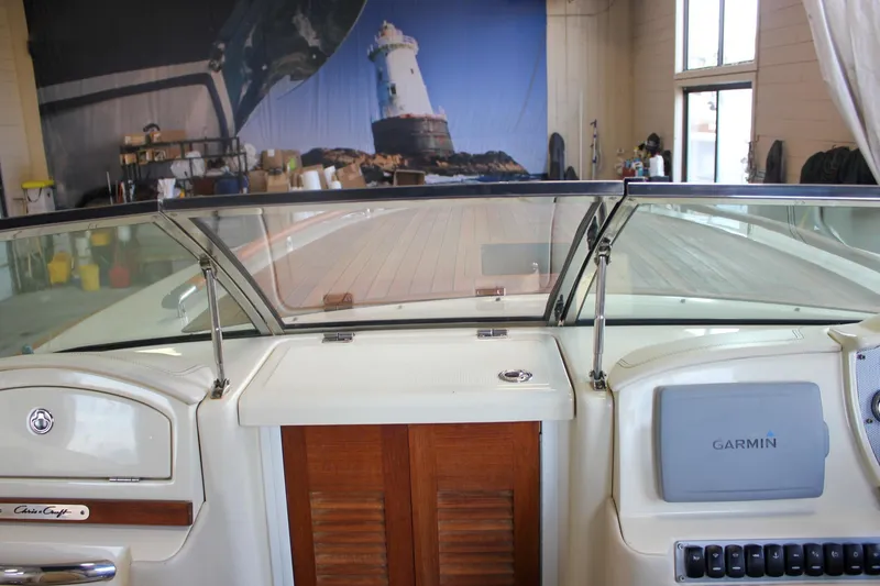 Slide: The Image of 2011 Chris-Craft Corsair 28 cabin interior with patterned cushions and hidden toilet. - 31