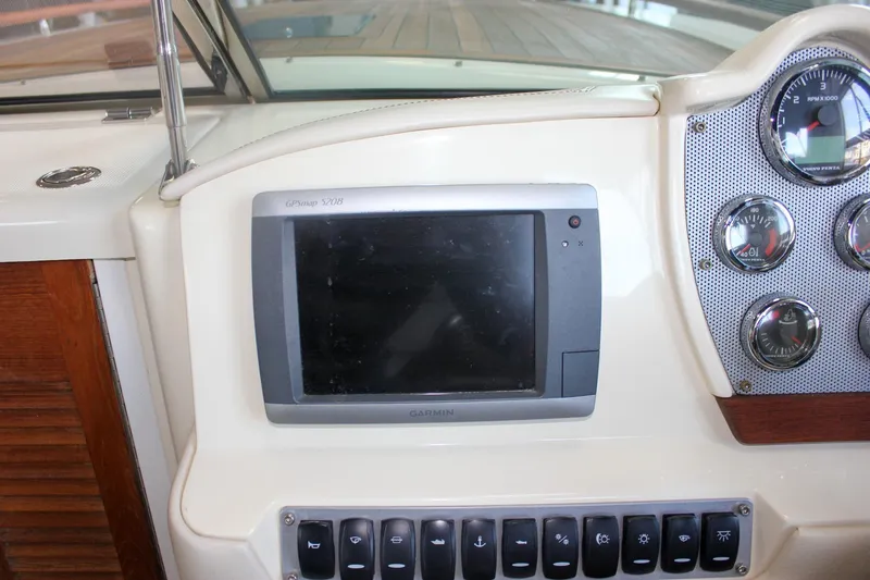 Slide: The Image of 2011 Chris-Craft Corsair 28 boat interior with built-in toilet and patterned seating. - 33