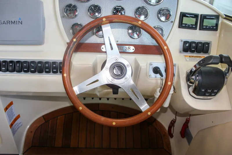 Slide: The Image of 2011 Chris-Craft Corsair 28 cabin interior with life jackets and patterned bedding. - 34