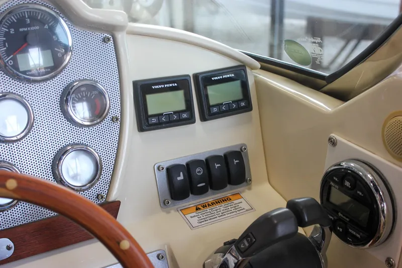 Slide: The Image of 2011 Chris-Craft Corsair 28 cabin interior with wooden door and patterned seating. - 35