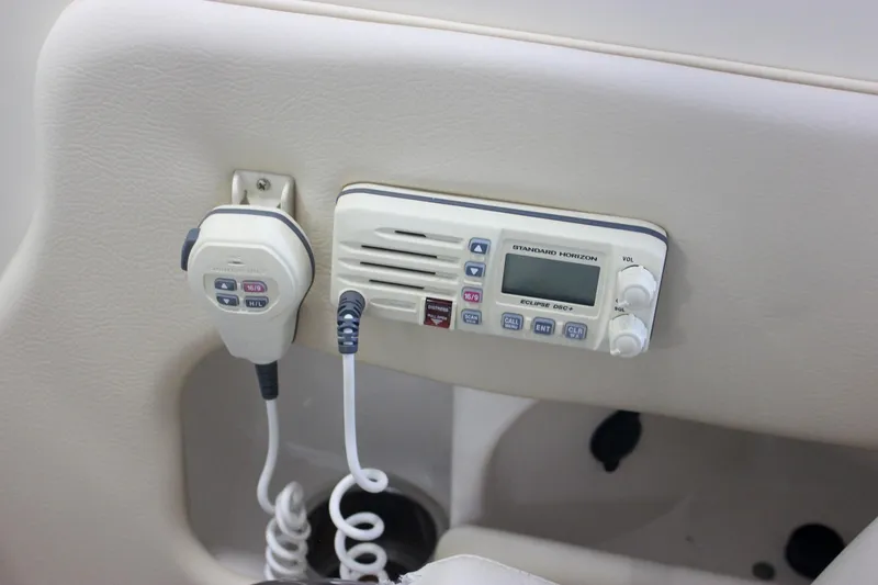 Slide: The Image of 2011 Chris-Craft Corsair 28 boat dashboard with Garmin navigation system and wooden steering wheel. - 38