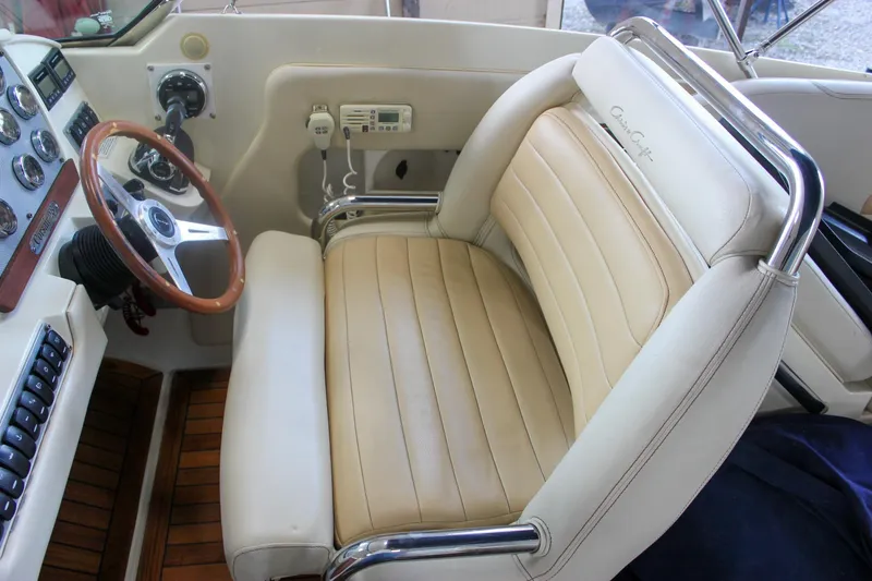 Slide: The Image of 2011 Chris-Craft Corsair 28 dashboard with wooden steering wheel and control panel. - 40