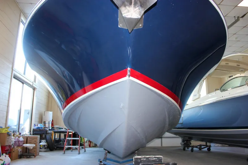 Slide: The Image of 2011 Chris-Craft Corsair 28 cockpit with beige leather seating and wooden steering wheel. - 46