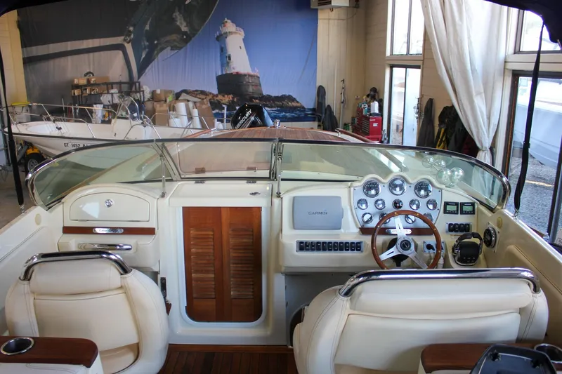 Slide: The Image of 2011 Chris-Craft Corsair 28 boat in indoor storage, showcasing elegant design and craftsmanship. - 49