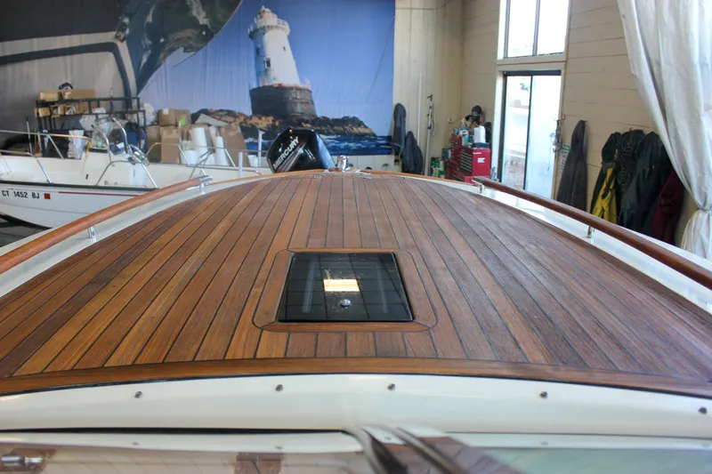 Slide: The Image of 2011 Chris-Craft Corsair 28 boat in storage, showcasing sleek blue hull design. - 52