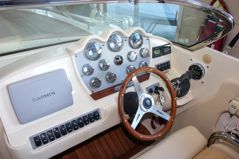 Slide: The Image of 2011 Chris-Craft Corsair 28 boat, blue hull with red stripe, indoor display. - 53